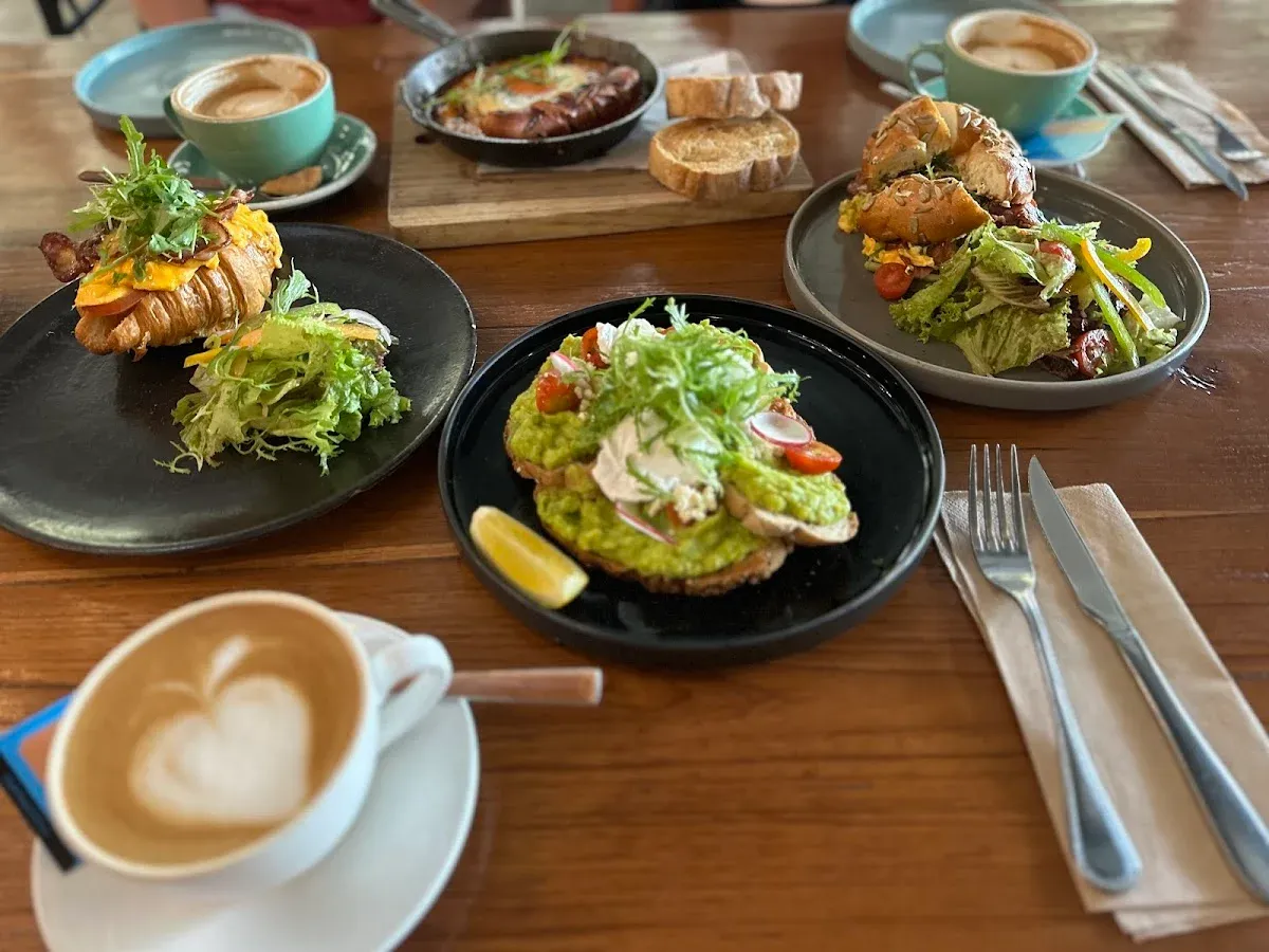 brunch table with salads, coffee, and plated food