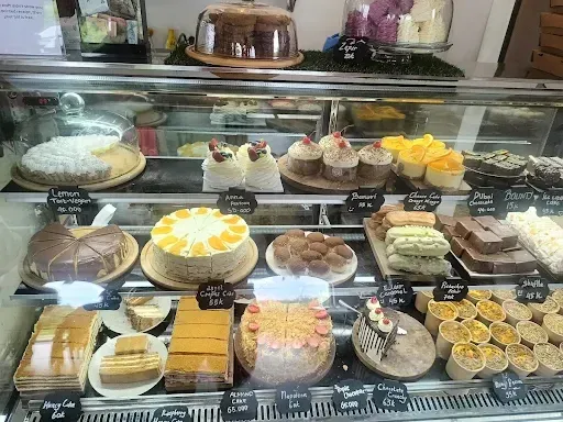 cake display counter with pastries and dessert slices