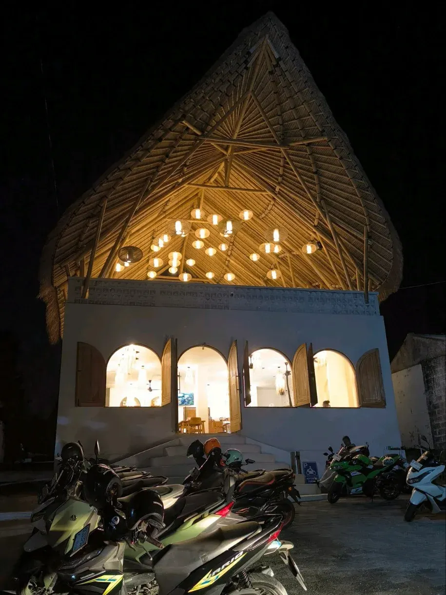 evening exterior of the cafe building with lit interior
