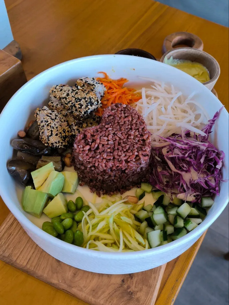 closer colorful rice bowl with vegetables and sauce